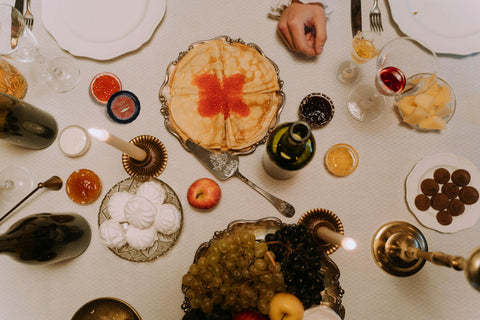 table setting with caviar, sauces, and sides