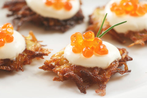 potato topped with an orange caviar and creme fraiche