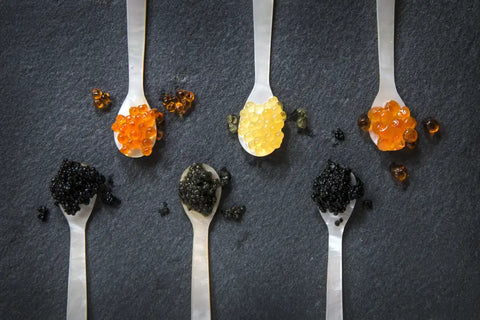 various types of caviar on spoons