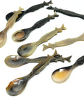 Sturgeon handle spoons made of horn on white background