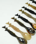 set of sturgeon shaped spoons on white background