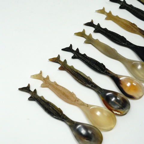 set of sturgeon shaped spoons on white background