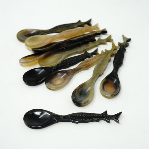 Set of decorative sturgeon shaped spoons on a white background