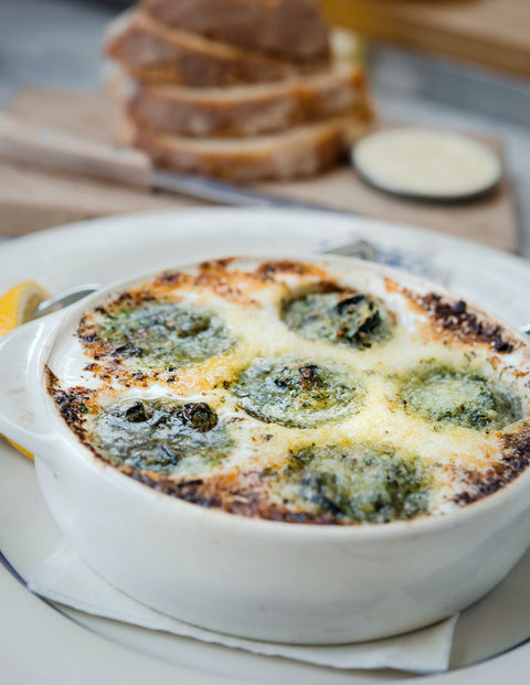 Cooked french escargot in dish