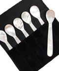 six mother of pearl serving spoons neatly packaged in velvet storage pouch.